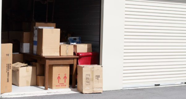 Blanket-wrapped household furniture in secure Buzz Movers storage between moving dates