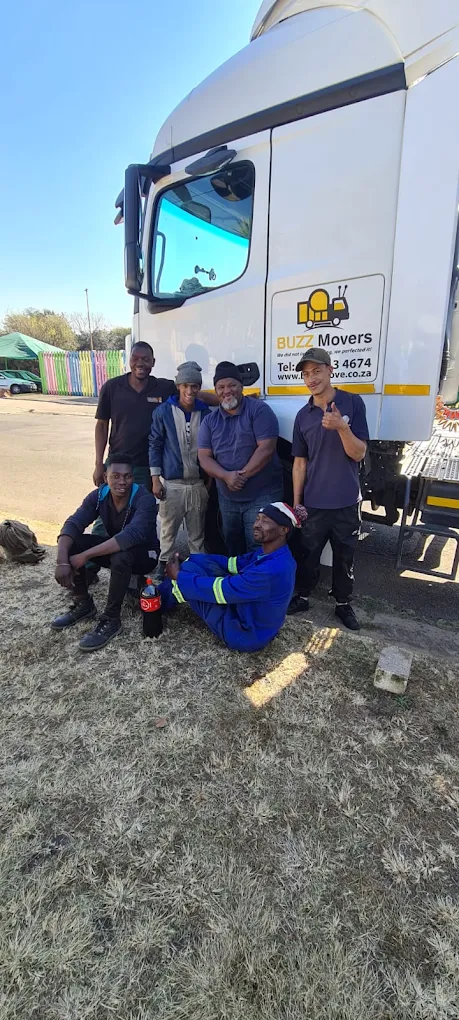 A Buzz Movers moving crew standing beside a branded truck