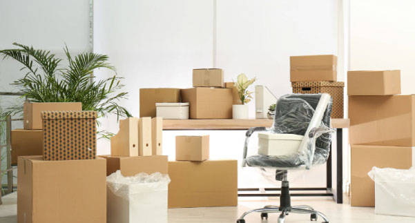 Alt: Buzz Movers crew relocating office furniture and labelled boxes during a business move
