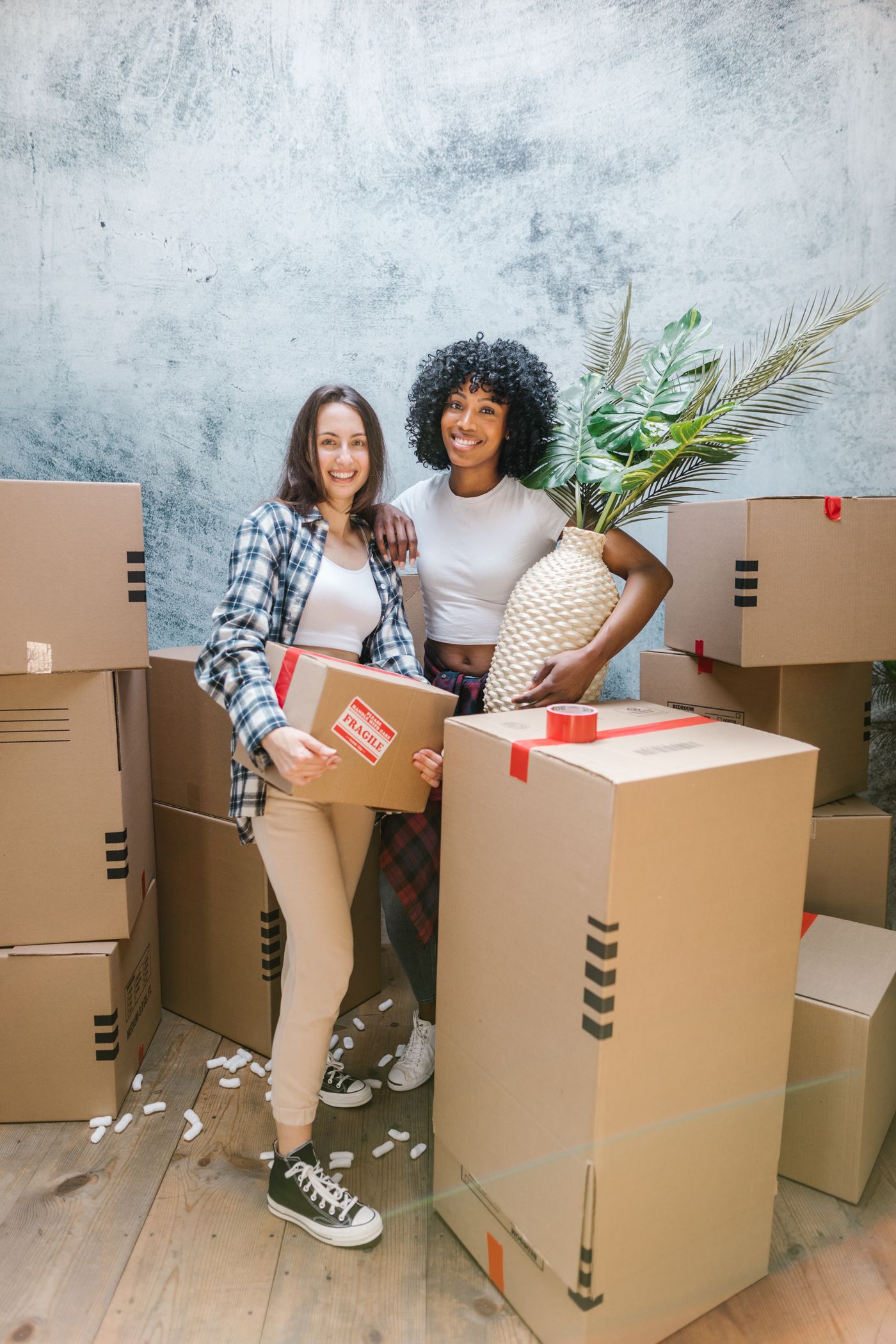 Couple packing moving boxes at home, illustrating furniture removals in Somerset West